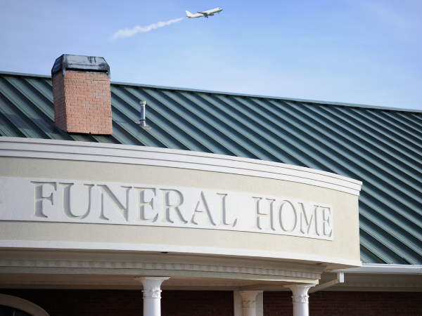 funeral home with a plane in the sky providing a body repatriation service